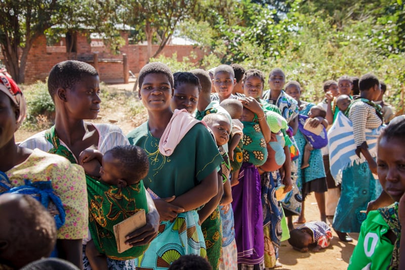 Moms in Malawi come to a vitamin distribution